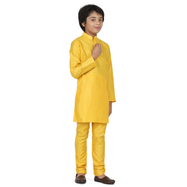 Boy wearing full sleeves yellow kurta set with black formal shoes